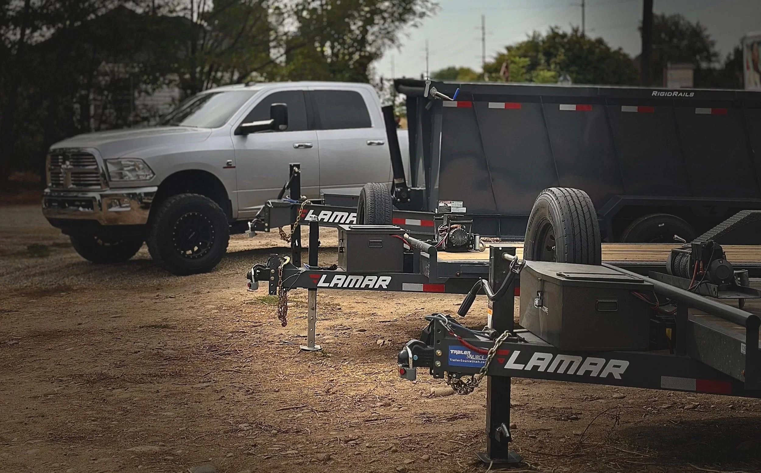 208 Trailer Rental dump and utility trailers with pickup truck at the fleet lot in Eagle, Idaho