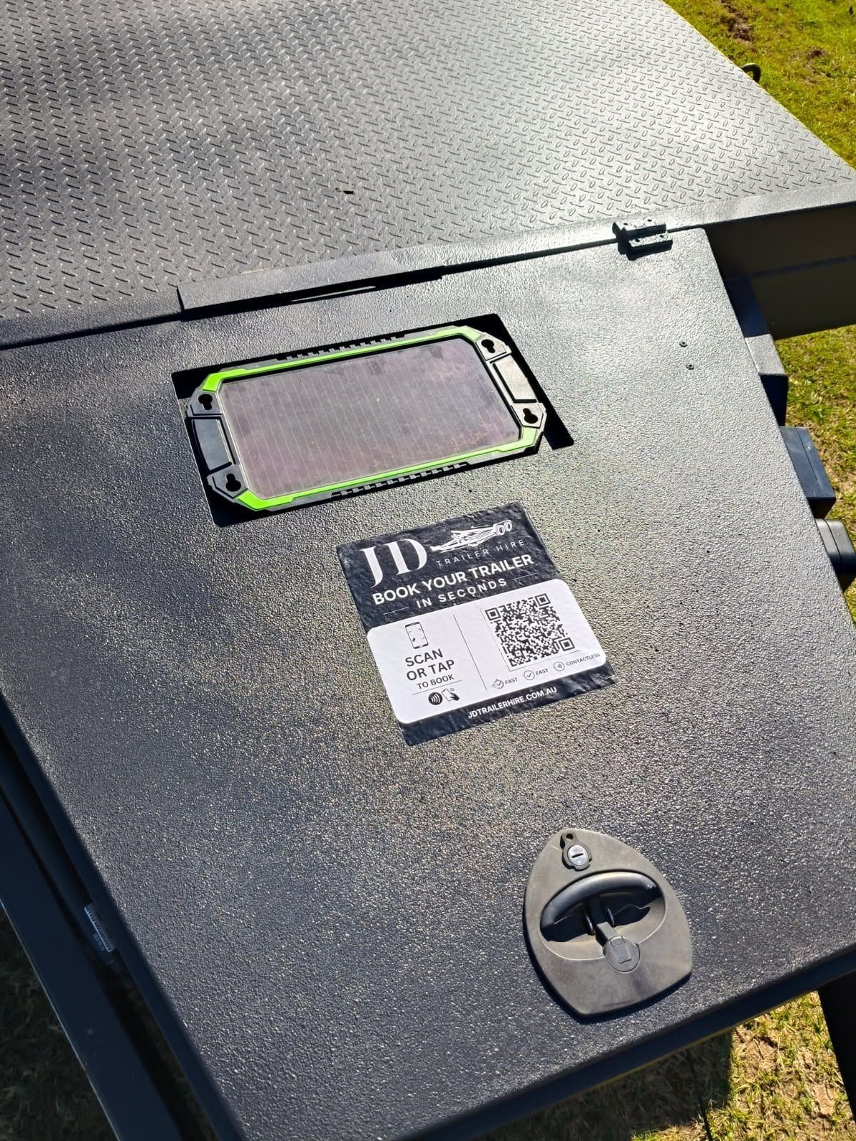 JD Trailer Hire NFC and QR code booking sticker on a trailer with solar panel
