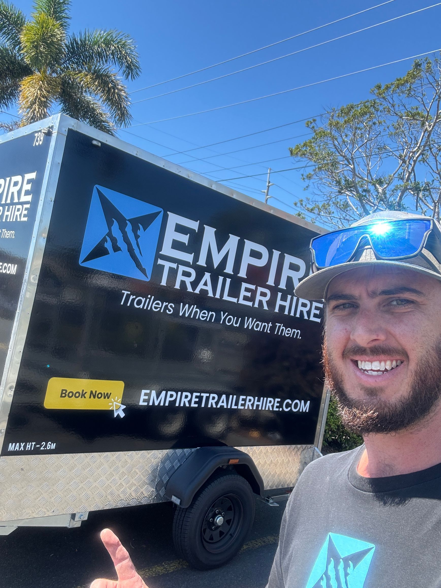 Matt Cole of Empire Trailer Hire standing beside a branded trailer