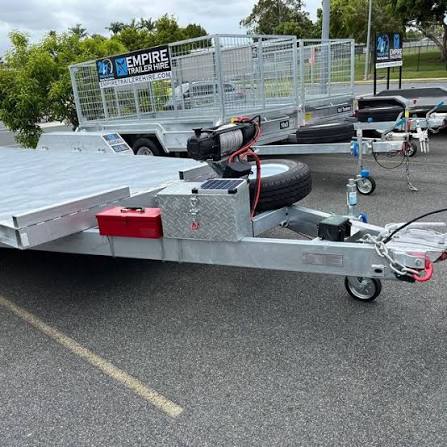 Empire Trailer Hire flatbed and cage trailers with 24/7 pickup signage