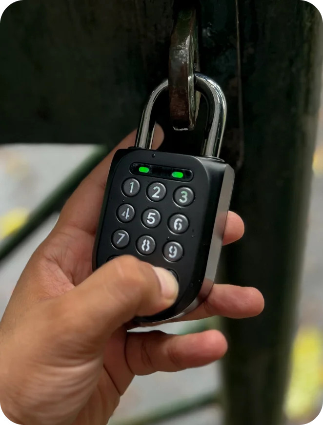 Hand entering a PIN on an igloohome keybox mounted outdoors